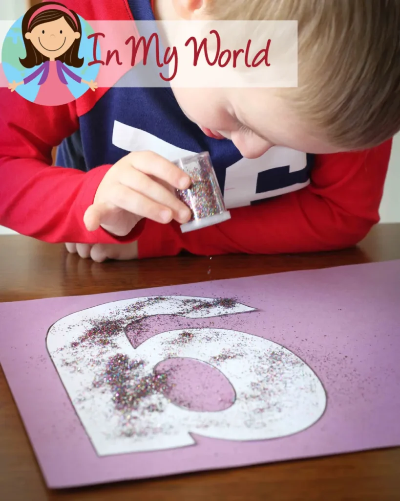 Preschool letter G craft activity with grass and glitter, combining creativity with learning about the /g/ sound. Free template available on the blog.