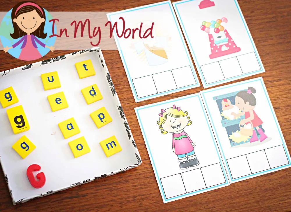 Child using letter tiles to build CVC words that start with G, practicing phoneme-grapheme mapping and spelling. Free printable activities available on the blog.