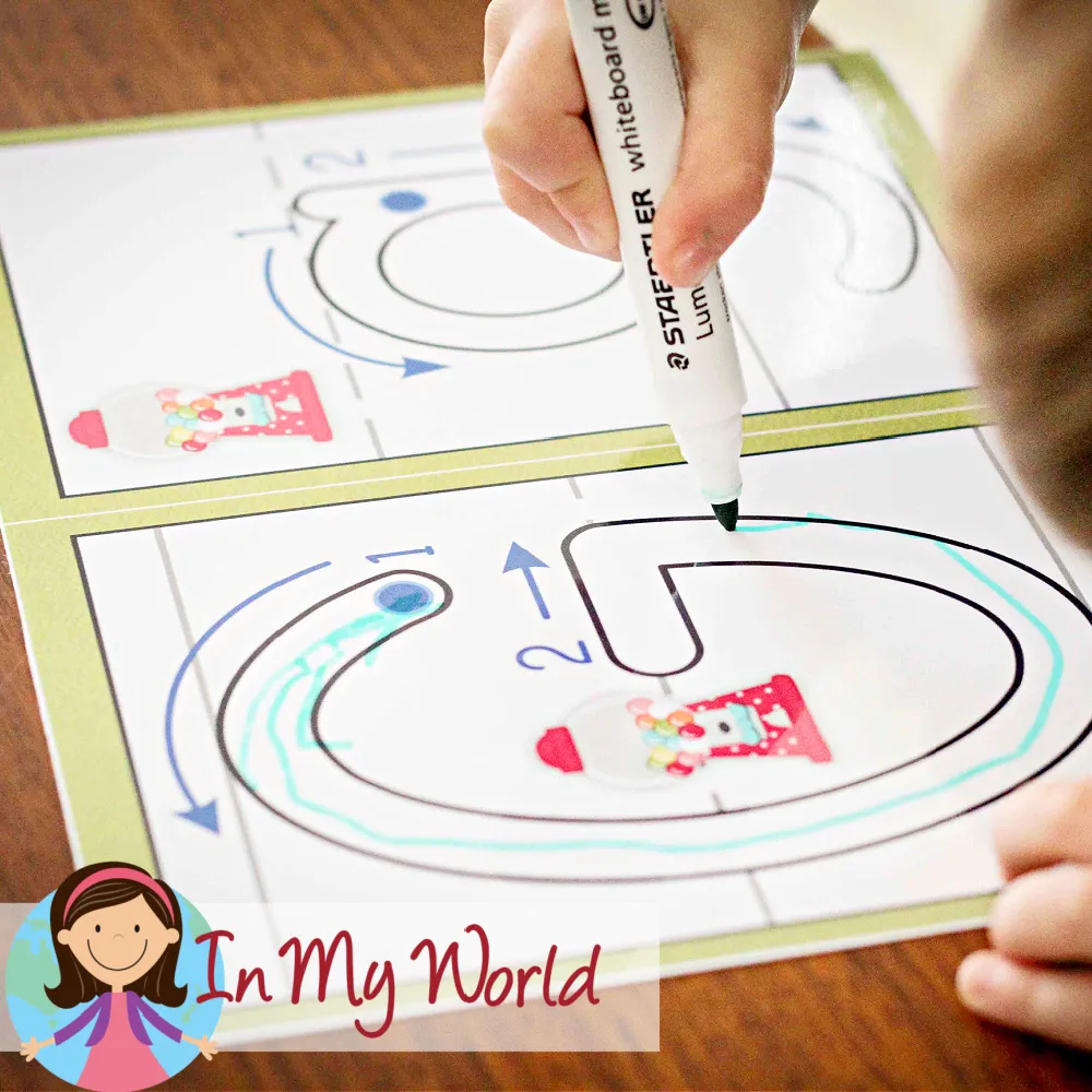 Child tracing the letter G on an alphabet play dough mat to practice correct letter formation. Free printables available on the blog.