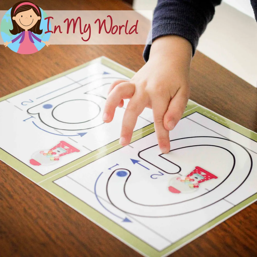 Child finger tracing the letter G on an alphabet play dough mat to practice correct letter formation. Free printables available on the blog.