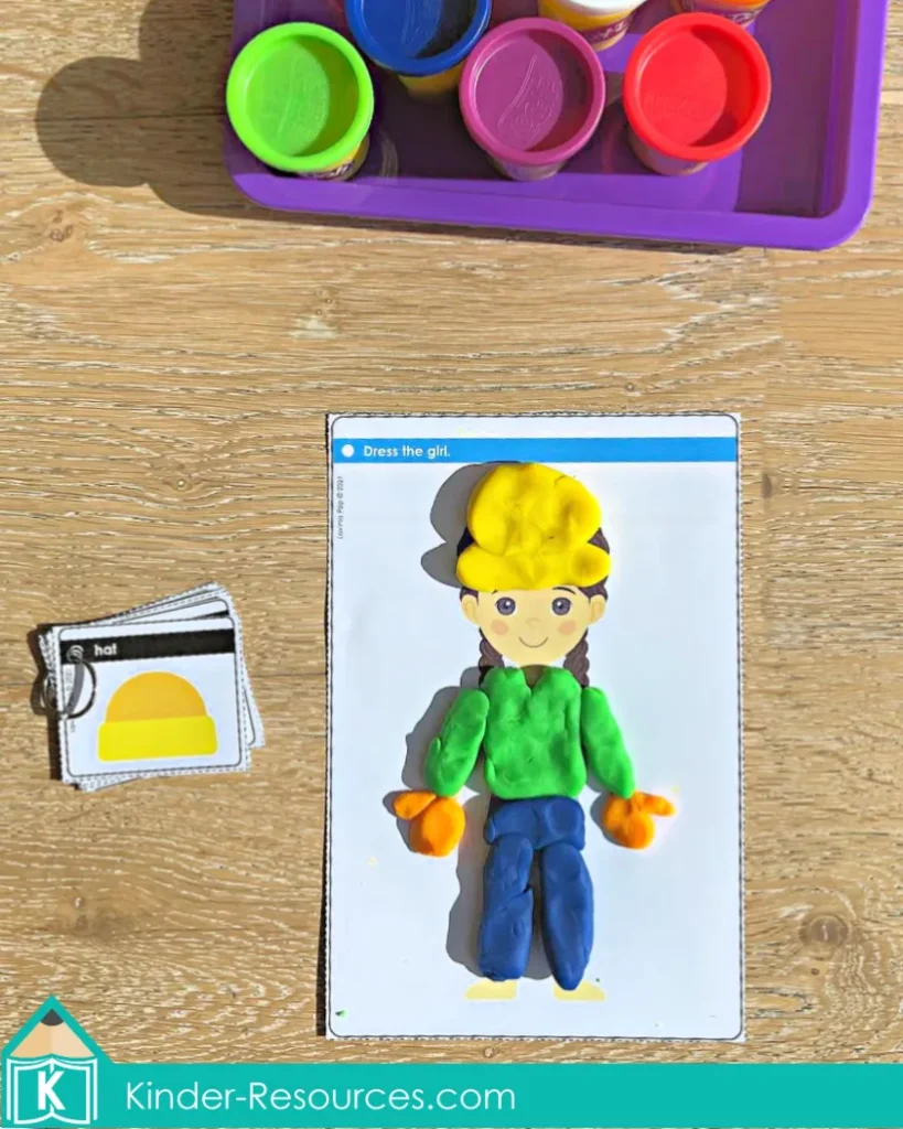 Hands-on playdough activity for preschool and kindergarten morning tubs. Children choose a card and use colored playdough to make clothing for the boy or girl to match the prompt. Builds fine motor strength, color recognition, and creativity. Perfect for centers or small groups. Free sample pages available on the blog.