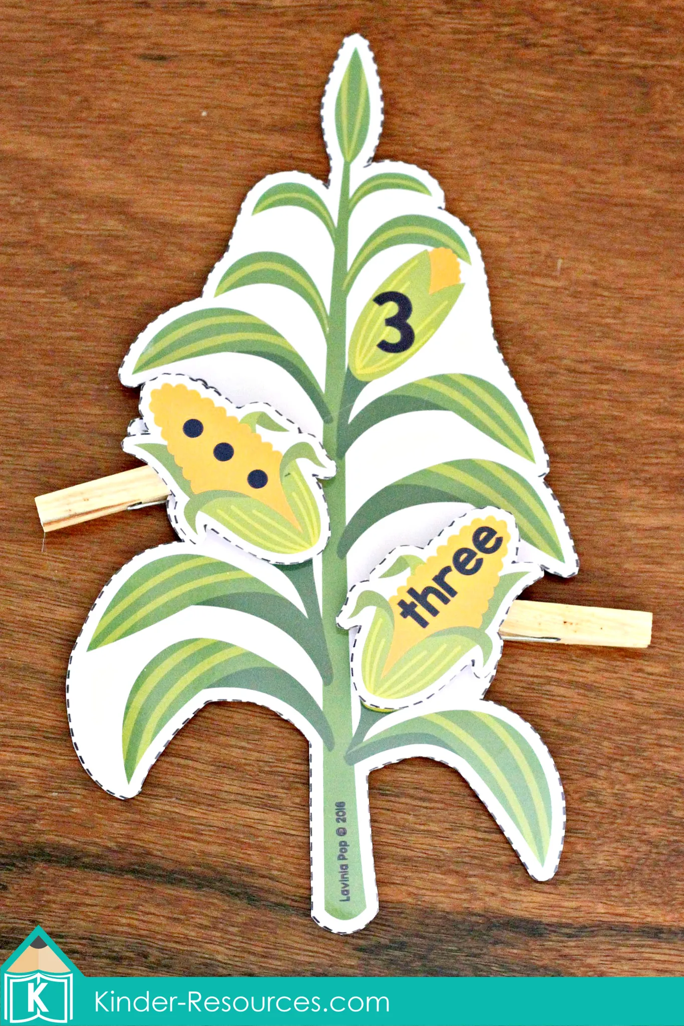 Corn number match activity showing a corn stalk labeled with number 3 and matching corn pieces for counting dots and number words in preschool math centers