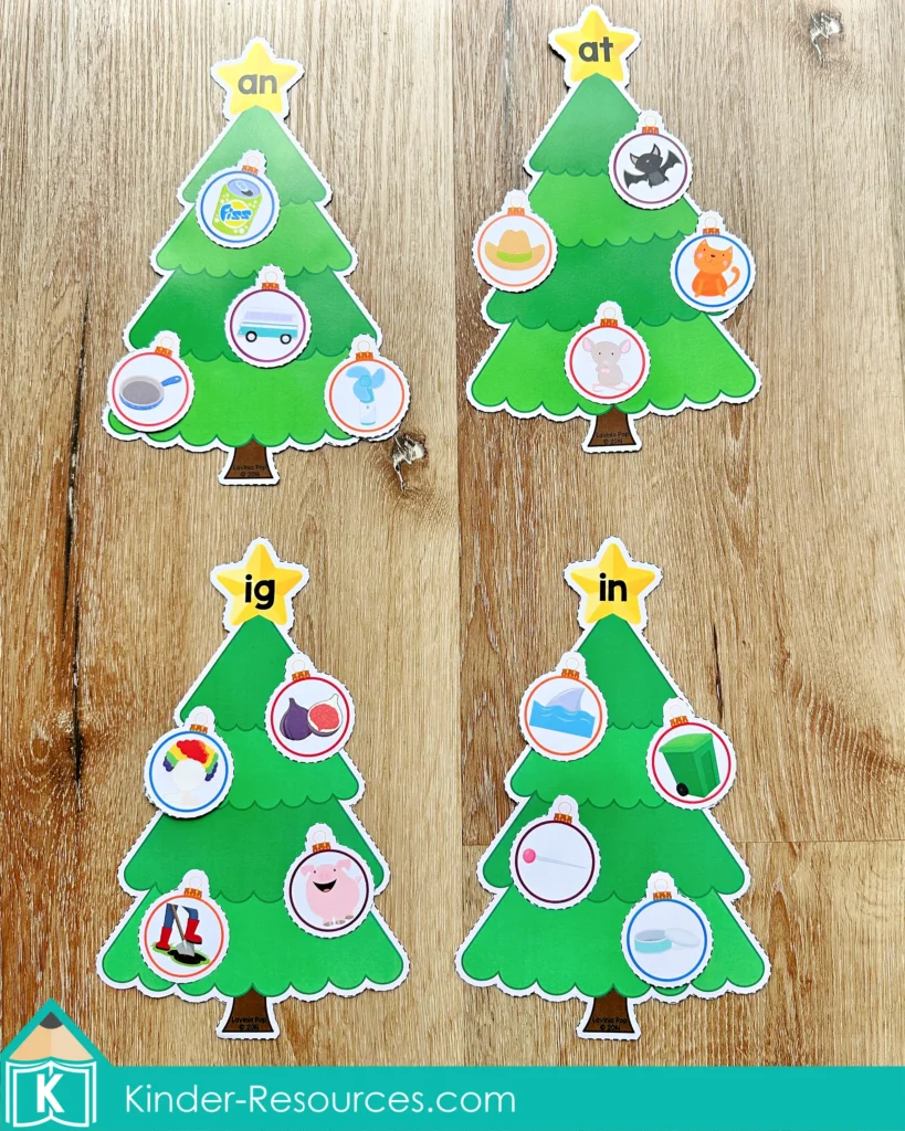 Christmas Literacy Centers for Kindergarten word family sorting trees labeled an, at, ig, and in with matching picture ornaments