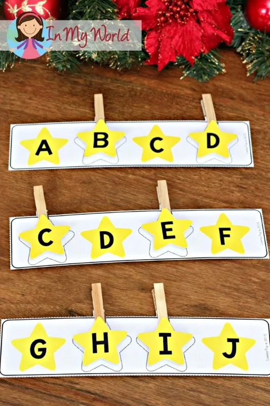 Christmas Nativity Centers for Preschool missing letter clip cards with yellow star alphabet strips where children clip the correct letter to complete the sequence.