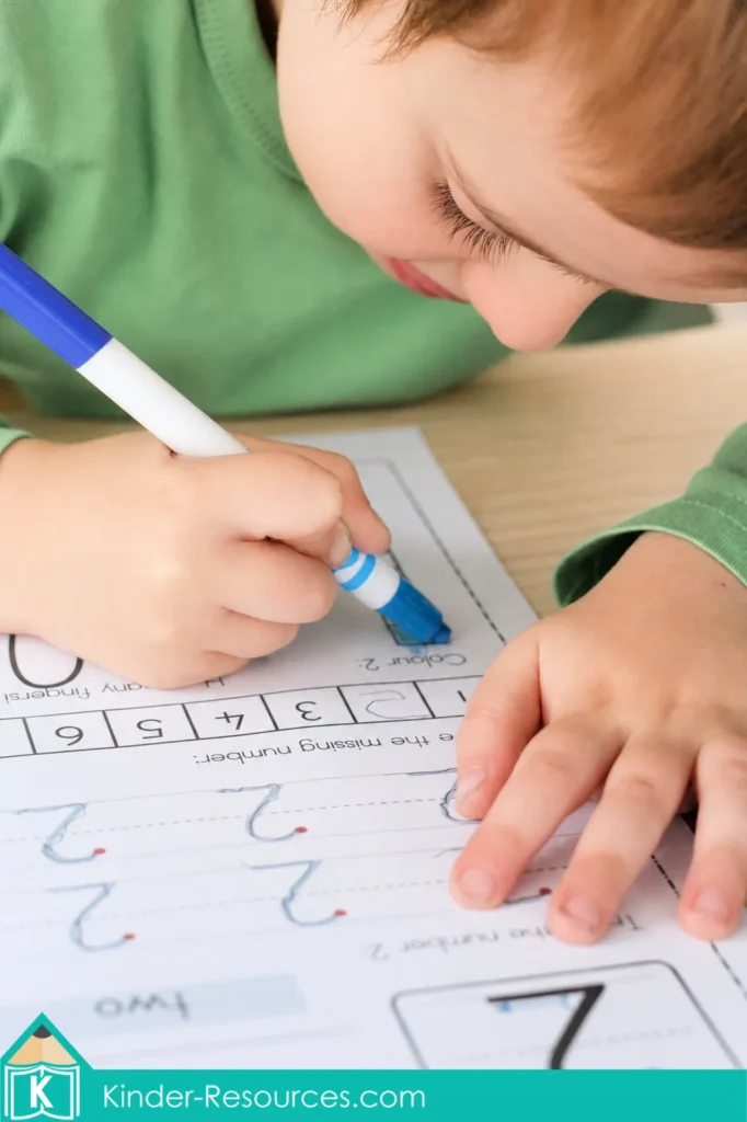 Preschool Number 2 math activity with a child coloring numeral 2 blue and completing tracing and missing number tasks.