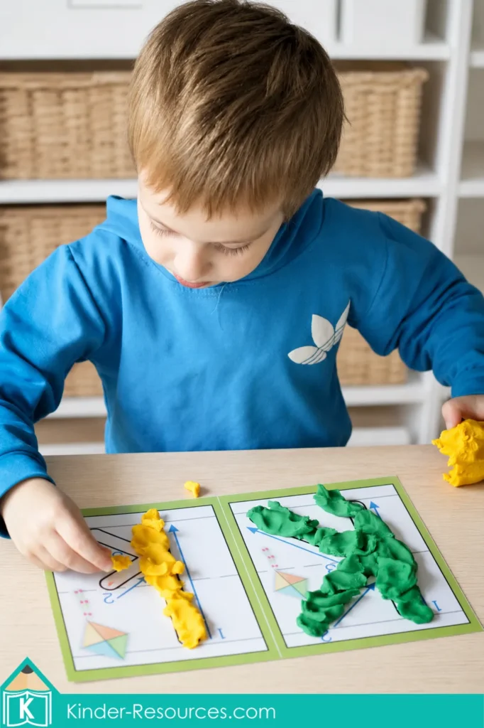 Child forming uppercase and lowercase K with green and yellow play dough during a preschool letter K fine motor activity.