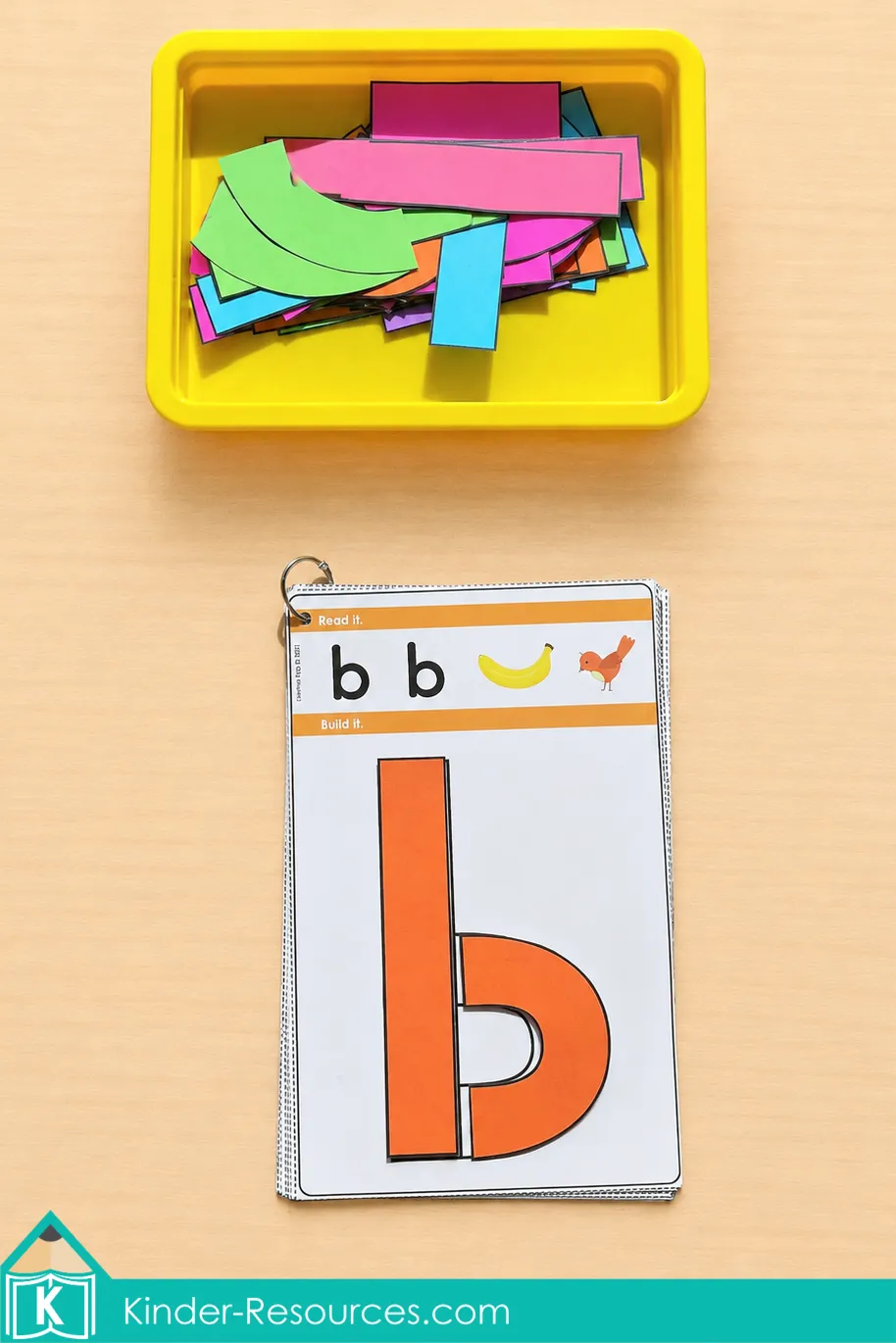 Building lowercase b with orange printable pieces on a ring-bound alphabet activity card.
