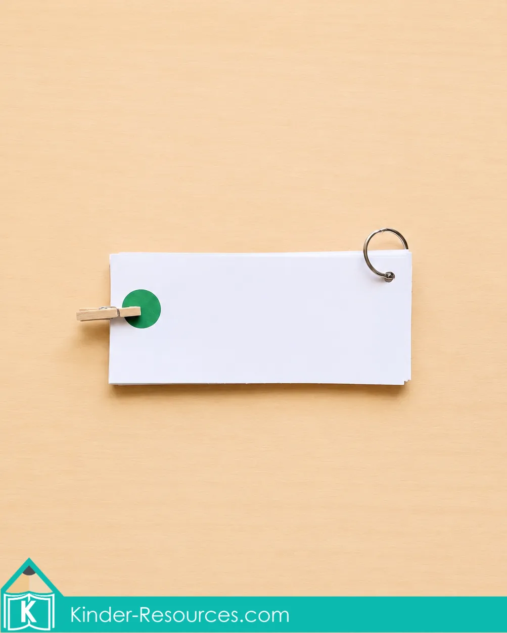 checking an answer on the back of a clip card using a green dot and wooden clothespin.