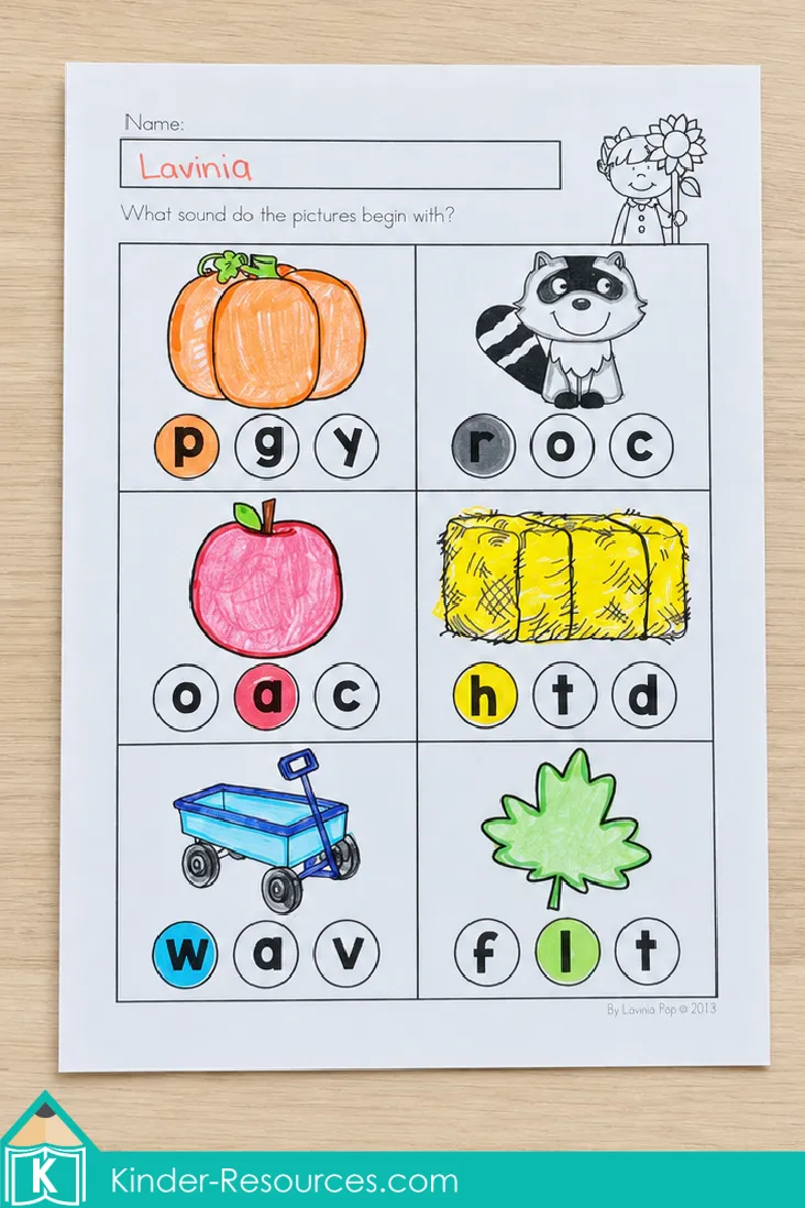 Identifying beginning sounds and coloring the correct letter beneath each fall picture on an autumn literacy worksheet for kindergarten.
