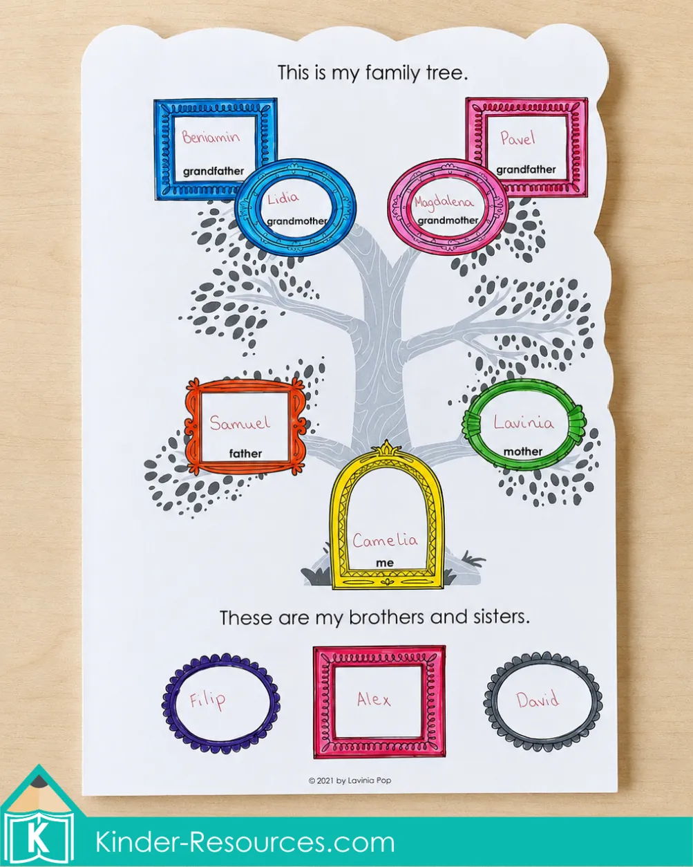 Completing a family tree page in a My Family Book by recording grandparents, parents, and siblings in colorful frames.