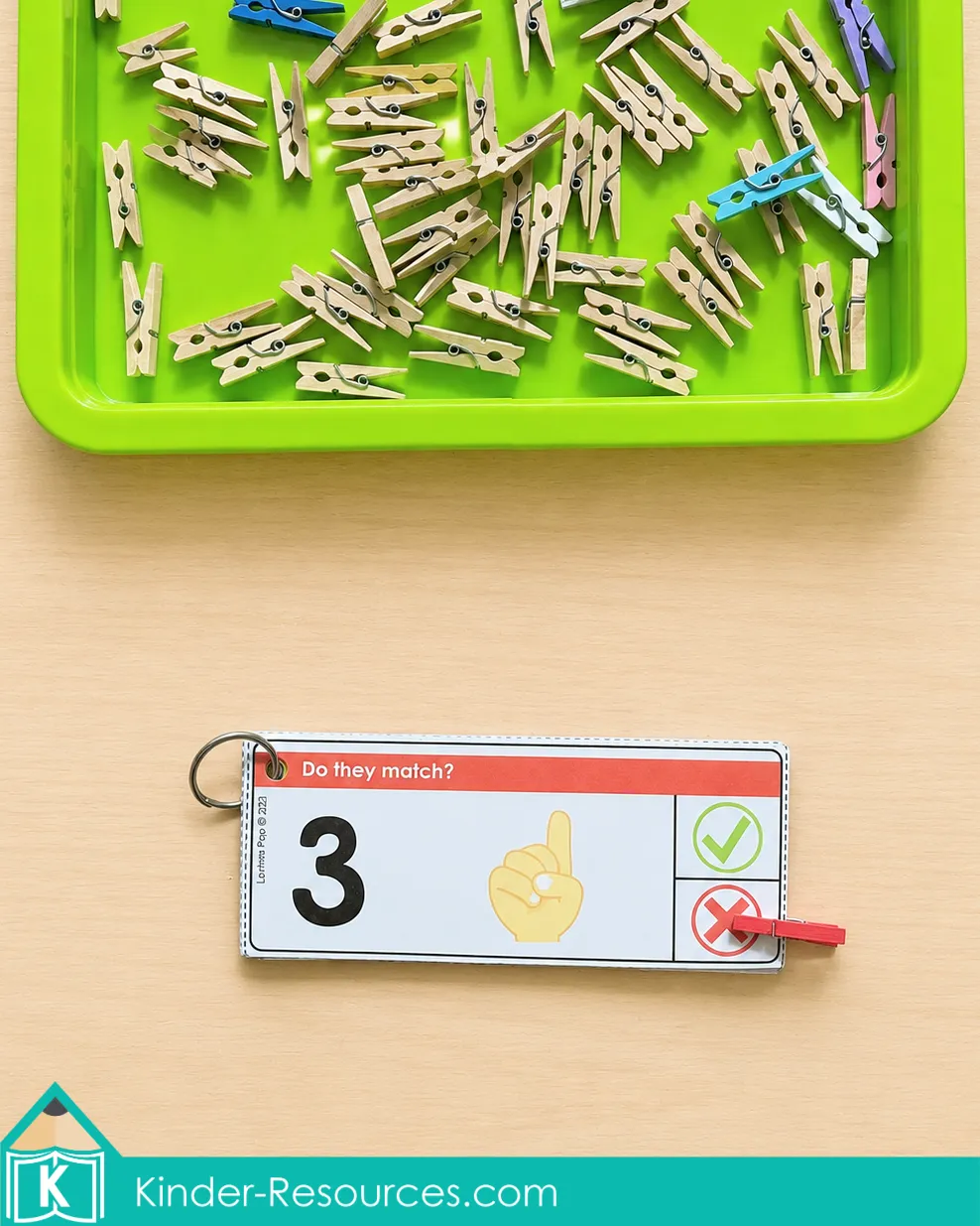 Using a red clothespin to show that numeral 3 does not match a hand showing one finger.