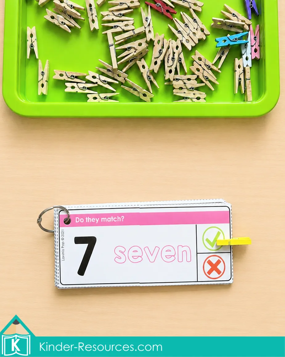 Matching the numeral 7 to the number word seven using a kindergarten clip card and yellow clothespin.