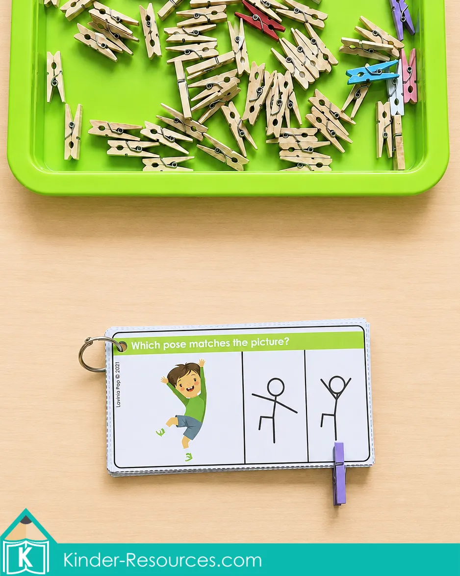 Matching a jumping boy to the correct stick-figure pose using a kindergarten clip card and purple clothespin.