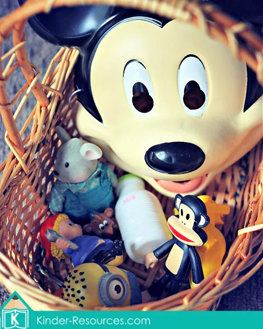 Preschool Letter M beginning sounds basket with a mouse, monkey, milk bottle, mitten, magnet, and marble for alphabet sound practice.