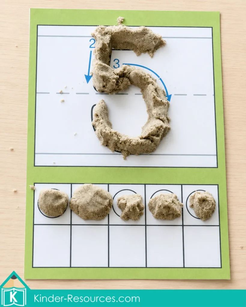 Preschool number 5 kinetic sand activity using grainy sand to form numeral 5 and place five portions on a ten frame.