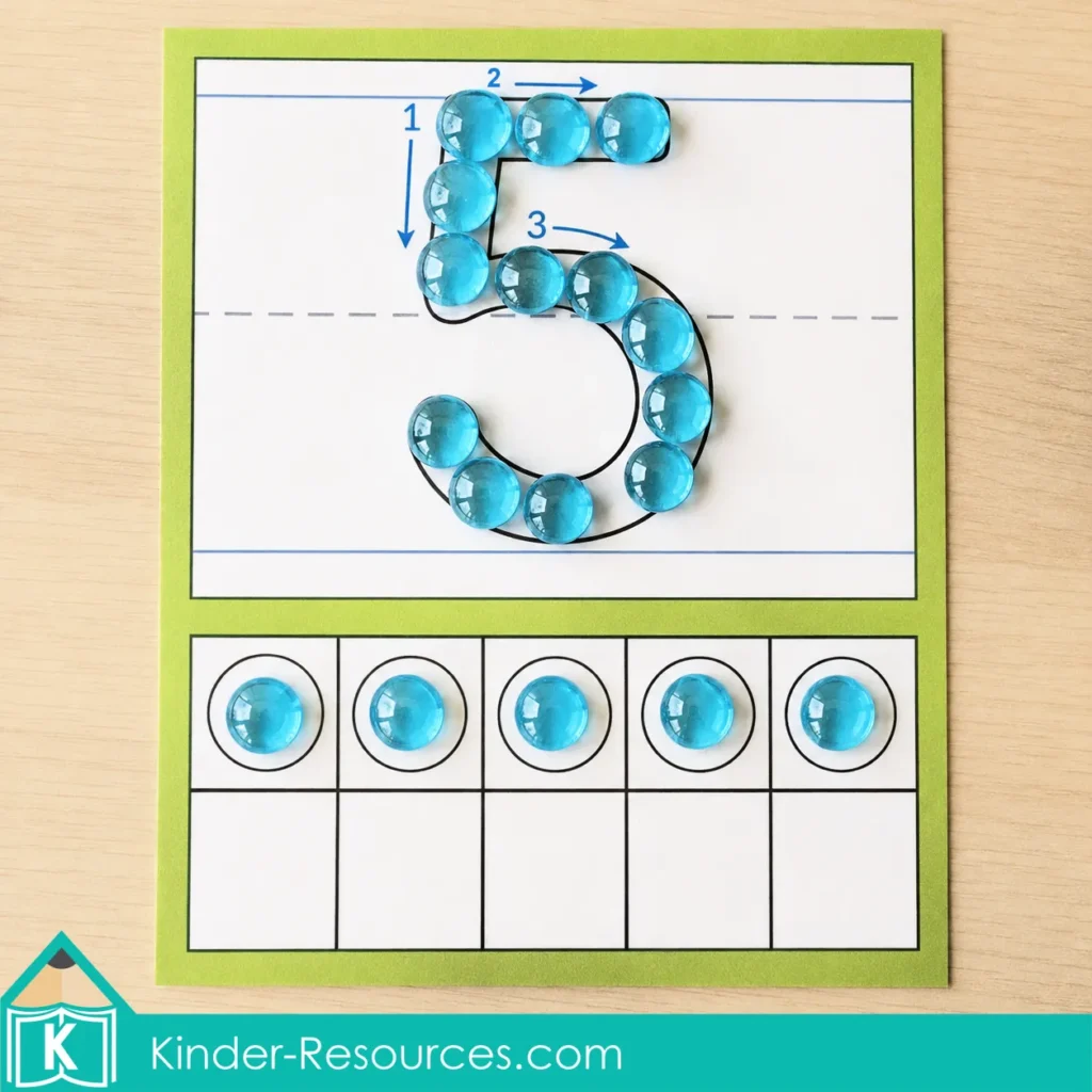 Completed preschool number 5 mat with translucent blue glass gems forming numeral 5 and five gems placed across the ten frame.