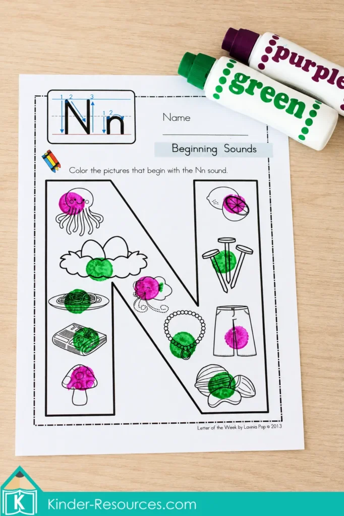 Letter N beginning sounds worksheet completed with green and purple bingo daubers for preschool phonics practice.