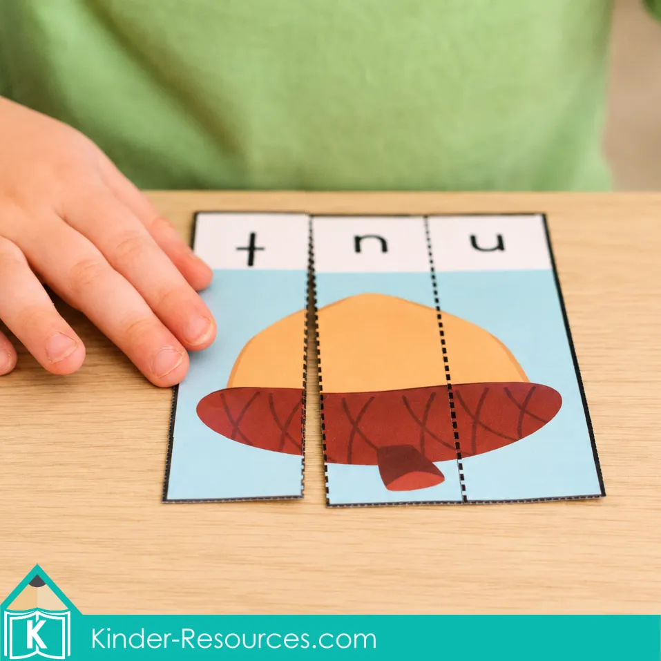 Child’s hand beside a three-piece nut CVC word puzzle with movable lowercase letter strips arranged in progress.