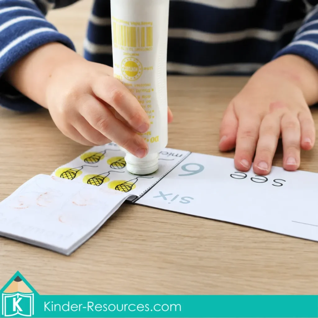 Preschool child using a dot marker to complete a number 6 counting and numeral mini-book activity.