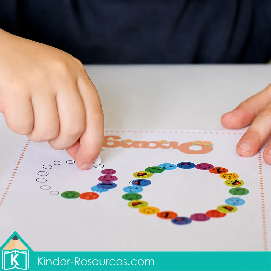 Using colorful emoji stickers to follow the formation path of lowercase o on a printable octopus letter mat.