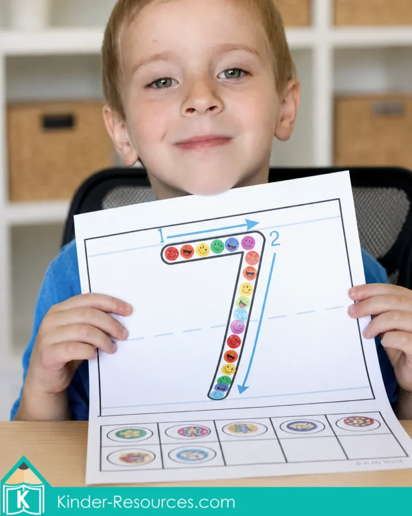 Completed printable number 7 formation mat decorated with colorful emoji stickers and a counting activity.