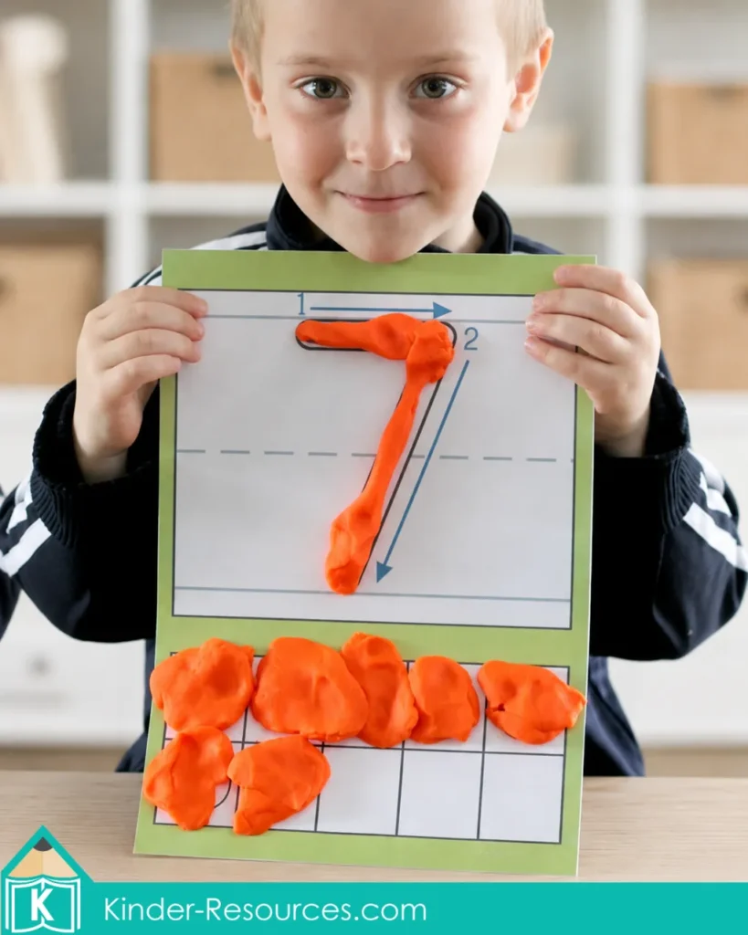 Using orange playdough to form the number 7 and model seven counters on a printable ten frame mat.