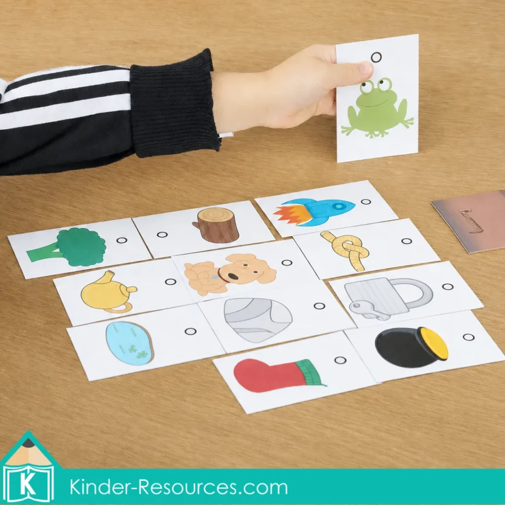 Sorting printable picture cards to identify words containing the short o sound during a hands on phonics activity.