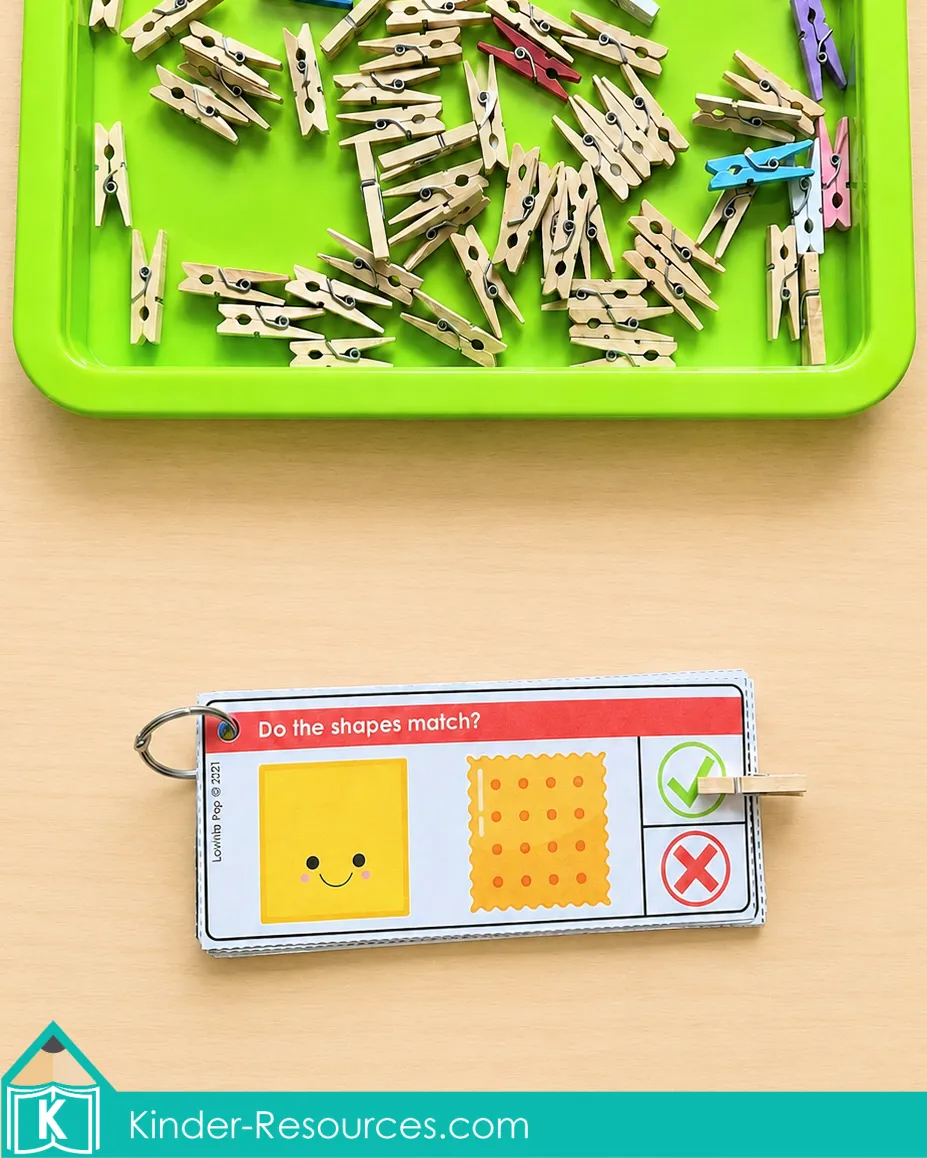 Using shape matching clip cards and a wooden clothespin to decide whether a square and cracker have the same shape.