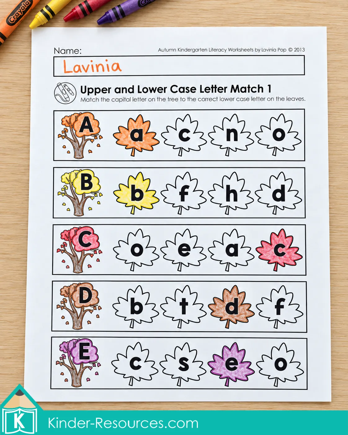 Kindergarten alphabet worksheet with uppercase letters on trees and matching lowercase letters colored on fall leaves.