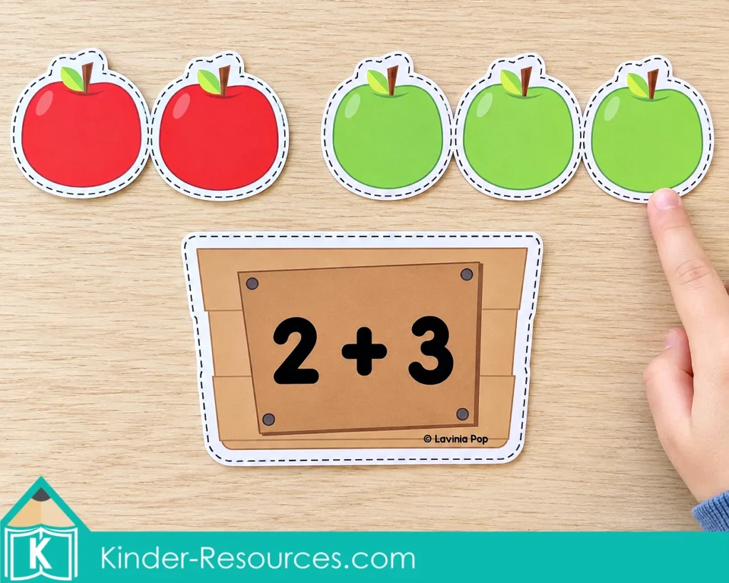 Two red apples and three green apples above a crate labeled 2 + 3, with a child pointing to the final apple.