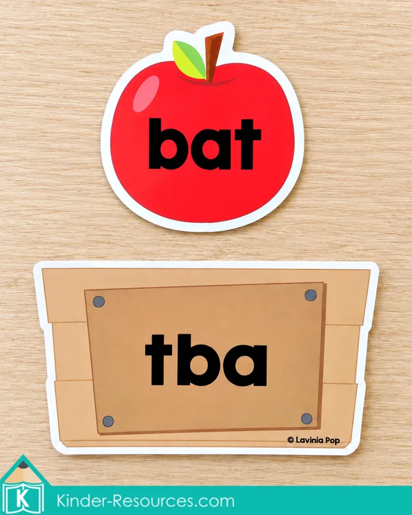 Red apple labeled bat above a crate showing the scrambled letters tba.