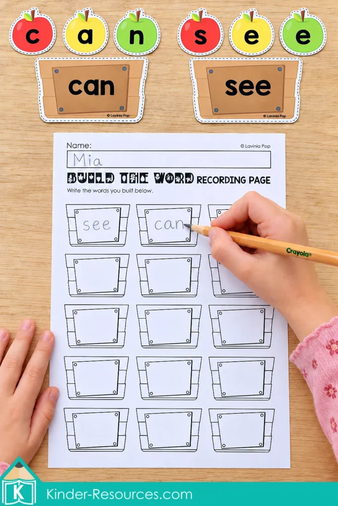 Child writing can and see on a recording page beneath matching word crates and apple letters.