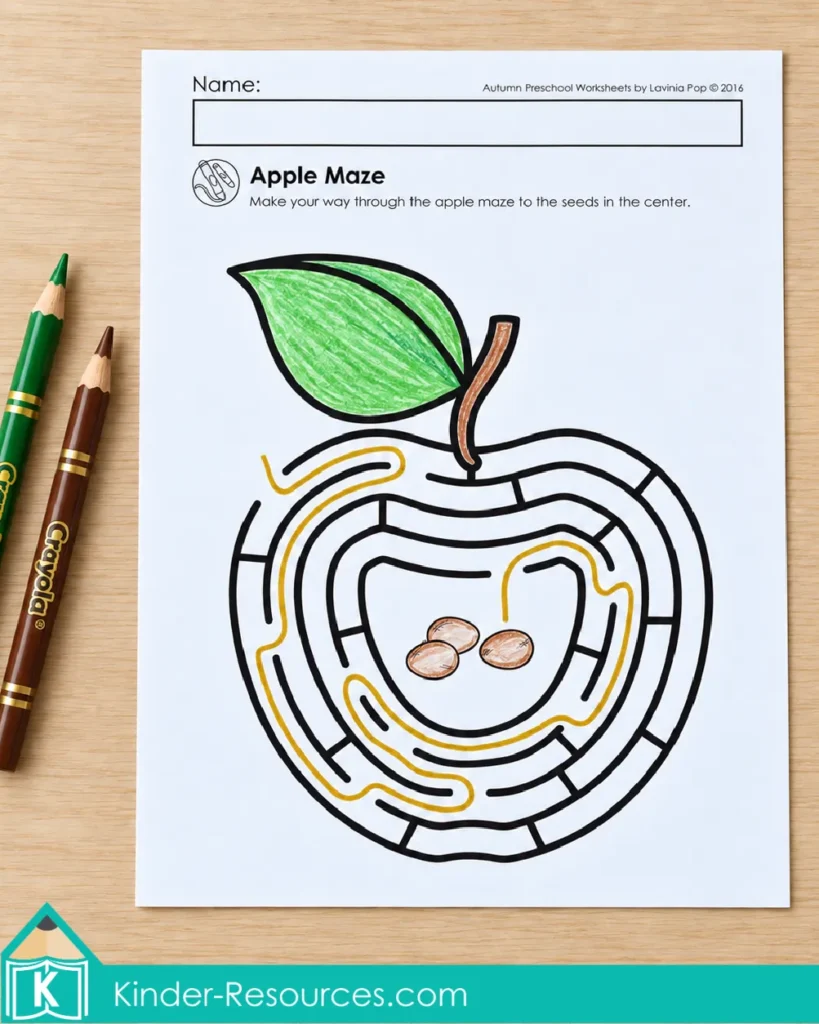 Preschool fall apple maze worksheet with a traced path to the seeds for pencil control practice.