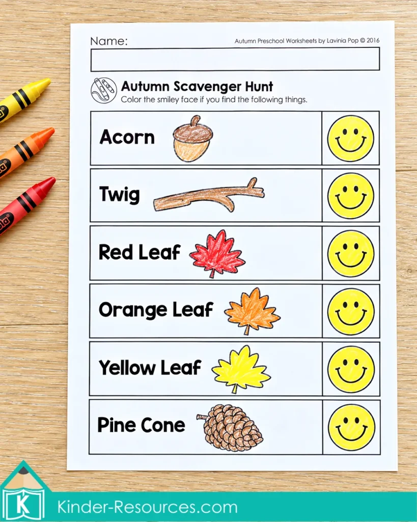 Preschool fall scavenger hunt checklist with an acorn, twig, red, orange, and yellow leaves, and a pine cone, with smiley faces colored to mark finds.