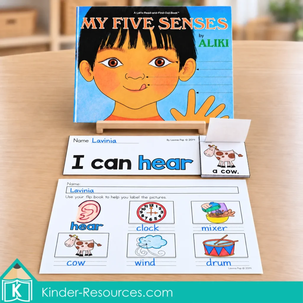My Five Senses by Aliki on a wooden stand beside a hearing book from the 5 senses flip books packet and a completed picture-labeling worksheet.